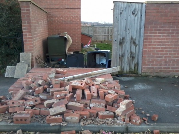 brick wall fallen onto pavement